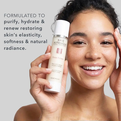 Rose + Cupuaçu Enzyme Cleanser bottle featured with model, an award-winning enzymatic facial cleanser for gentle exfoliation and hydrated skin